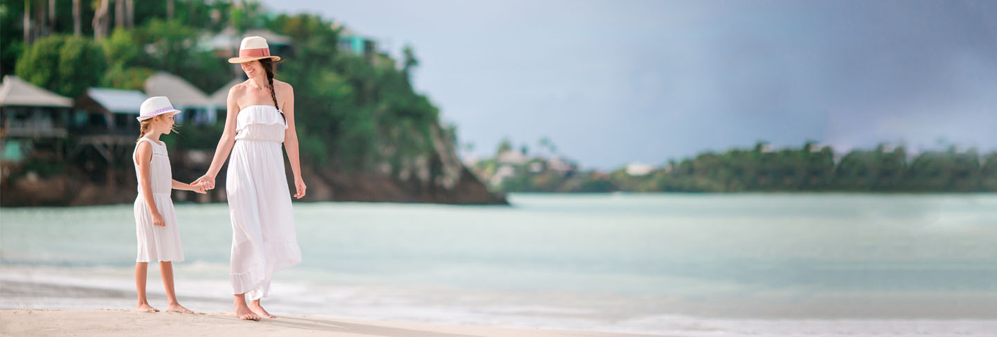 Beautiful mother and daughter on caribbean beach