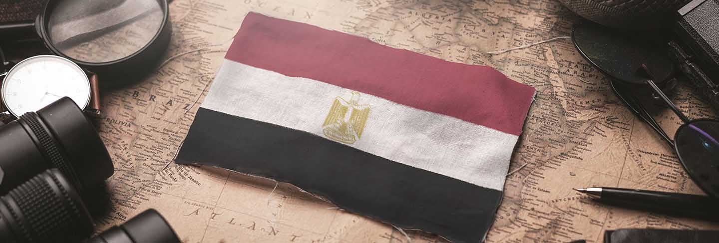 Egypt flag between traveler's accessories on old vintage map. tourist destination concept