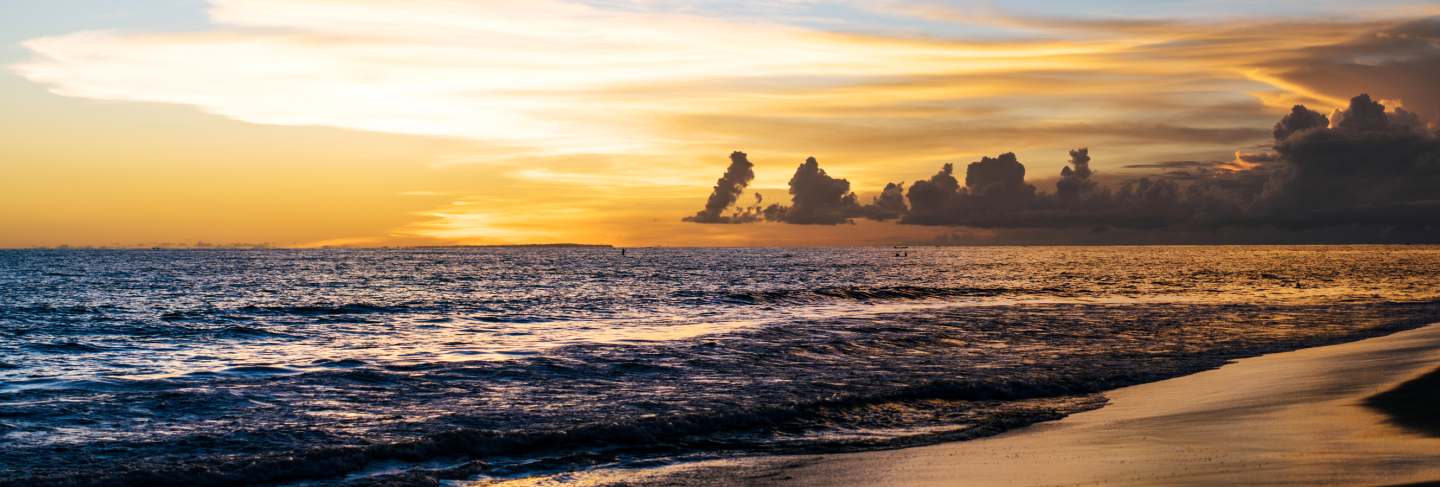 Sunset on the ocean. beautiful bright sky, reflection in water, waves.
