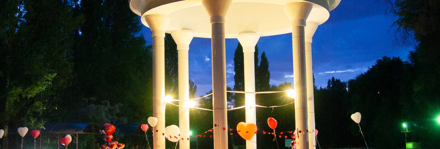 Gazebo in the middle of the lake at night
