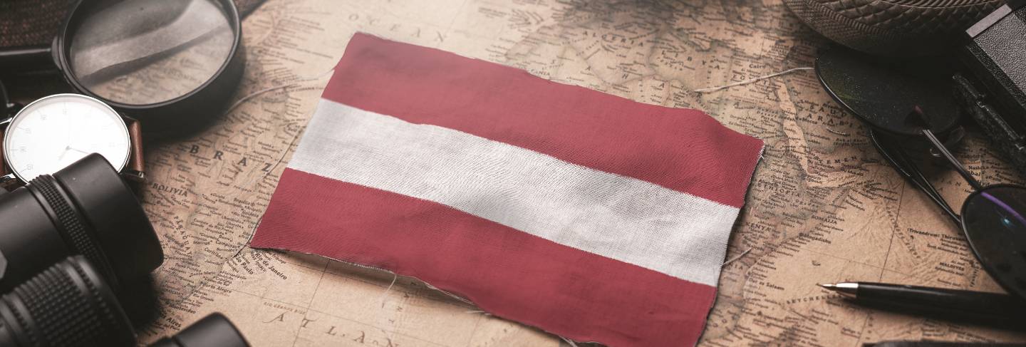 Austria flag between traveler's accessories on old vintage map. tourist destination concept.