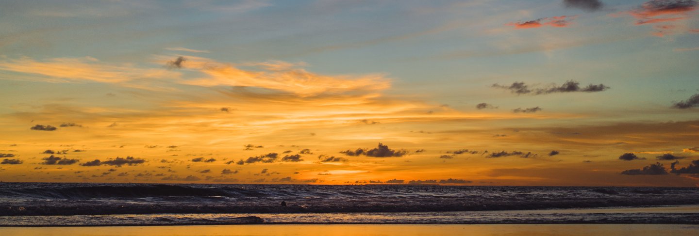 Sunset on the ocean. beautiful bright sky, reflection in water, waves.
