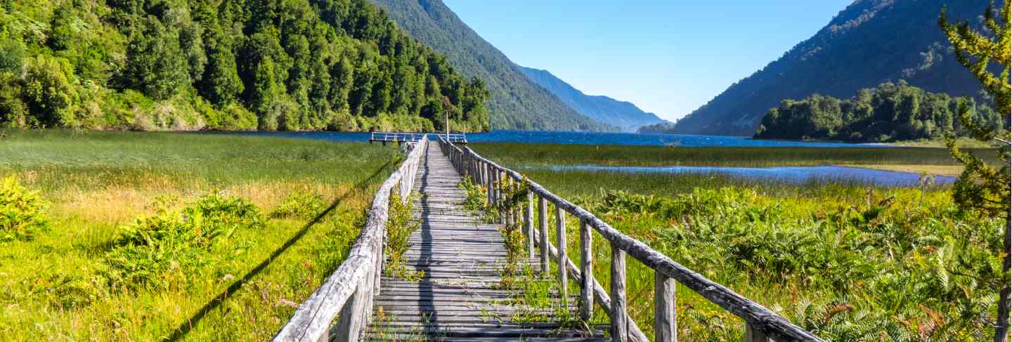 Wooden bridge across river murta, landscape with beautiful mountains view, patagonia, chile, south america
