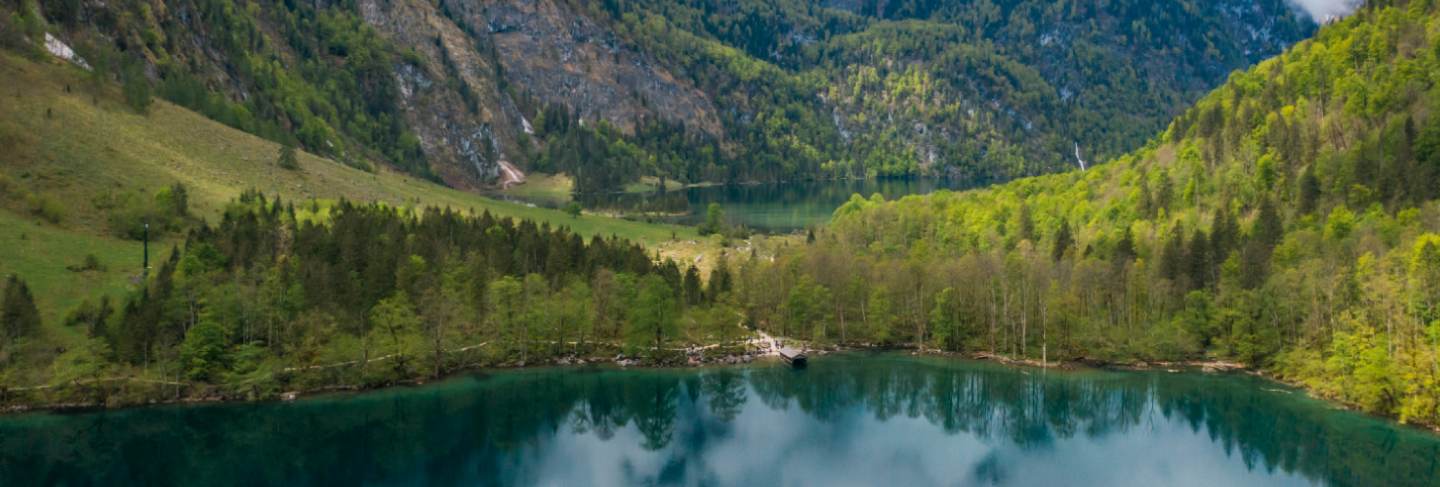 Scenic mountain panorama with green meadows and idyllic turquoise
