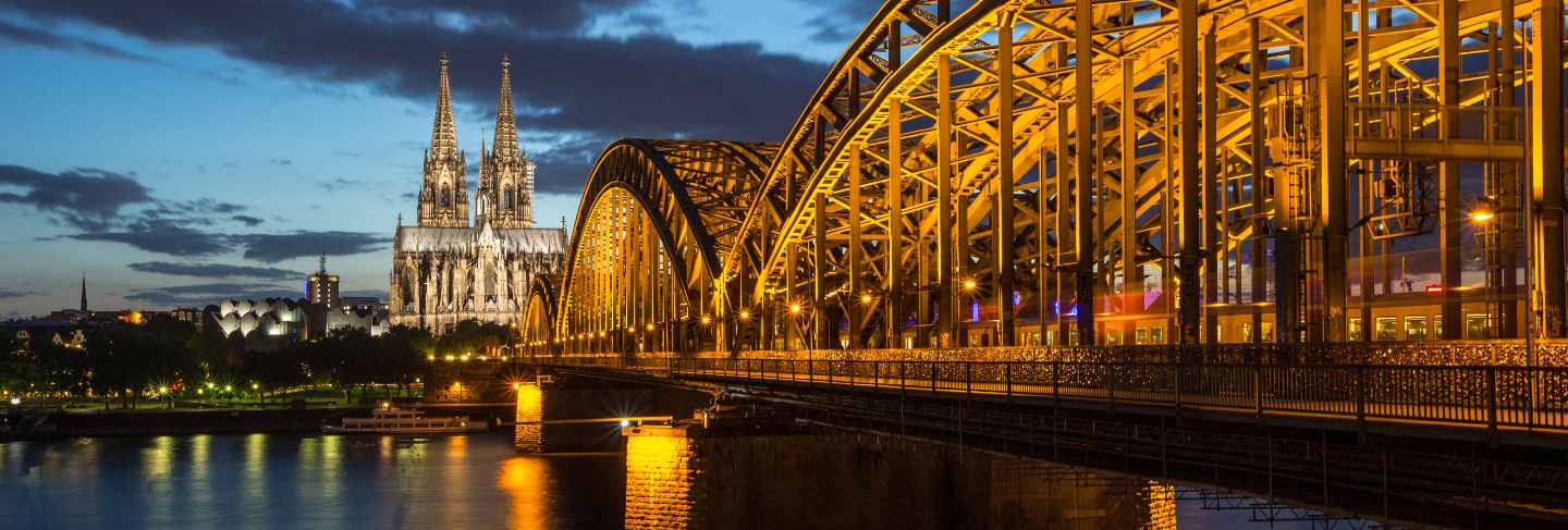 Famous cathedral and bridge in cologne at twilight
