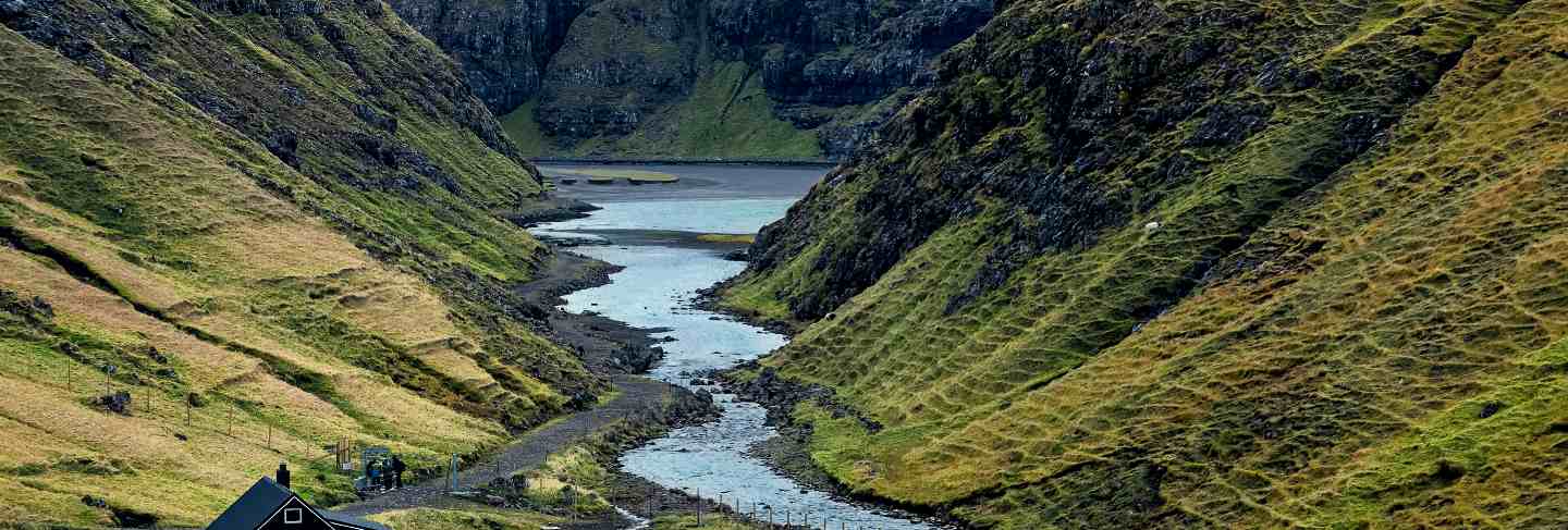 Small colored houses, fjords and the sea coast on faroe islands
