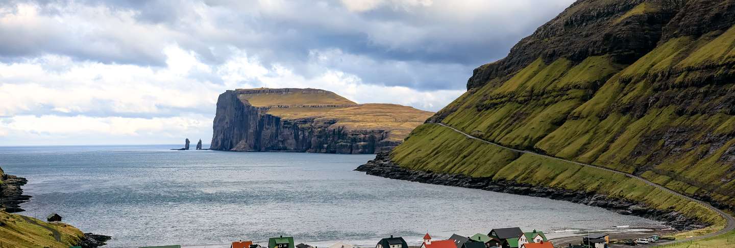 Tjornuvik village and two sea stacks on faroe islands 
