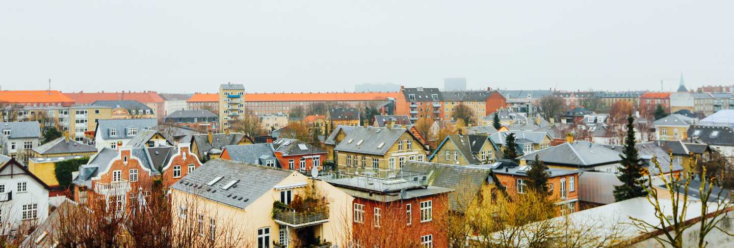 Wide shot of houses and buildings in the city of copenhagen
