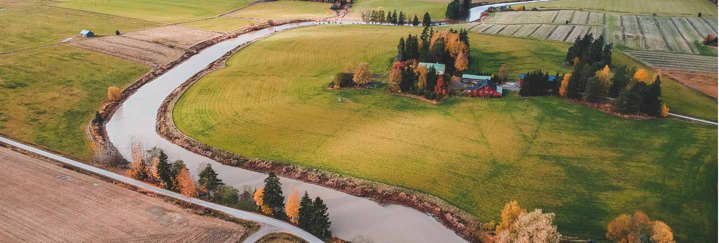 Aerial view of fertile plowed fields and forests. photo taken from a drone. finland, pornainen
