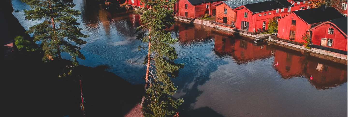 Aerial view of the old red house and barns by the river
