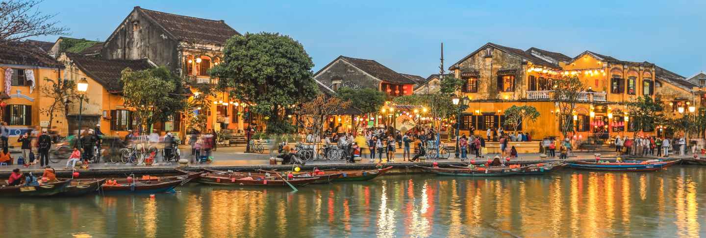 Full of tourists walking on street in hoi an ancient town at dusk