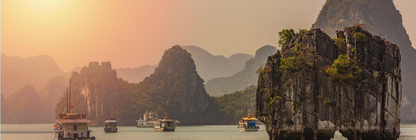 Tourist junks floating among limestone rocks at ha long bay