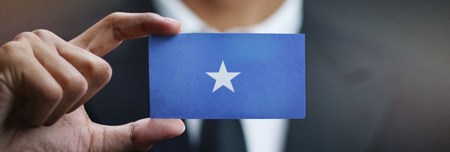 Businessman holding card of somalia flag
