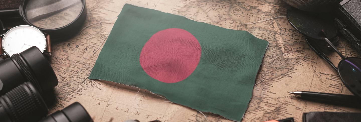 Bangladesh flag between traveler's accessories on old vintage map. tourist destination concept.