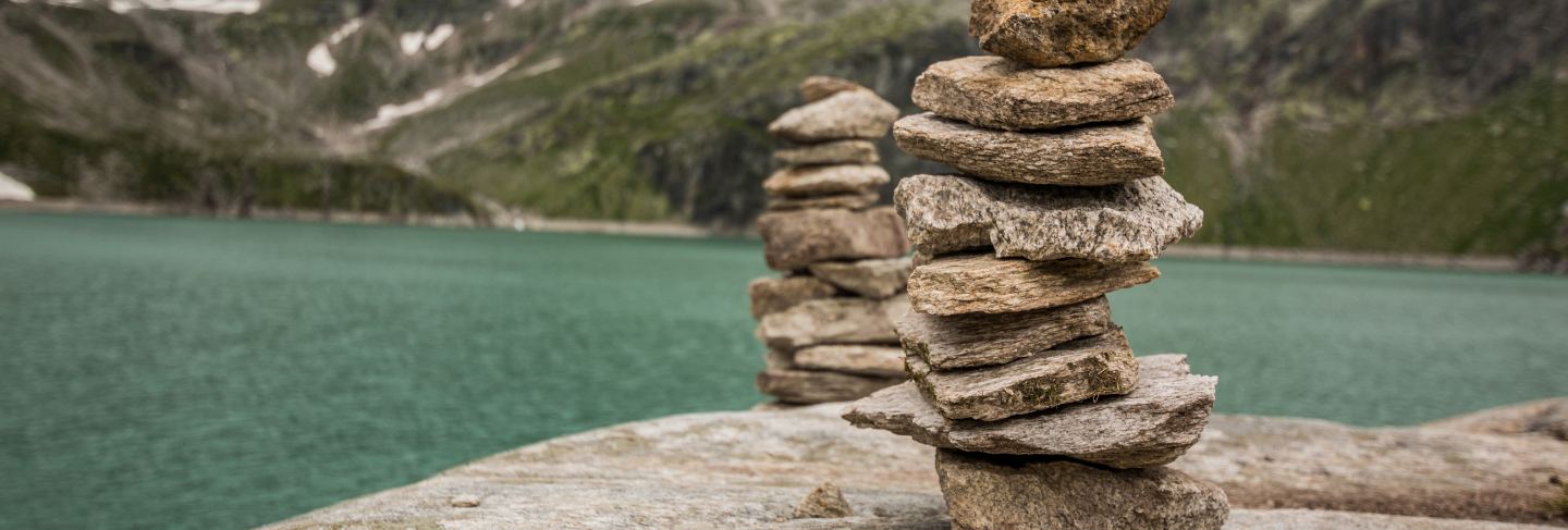 Stone tower with the mountain lake in background