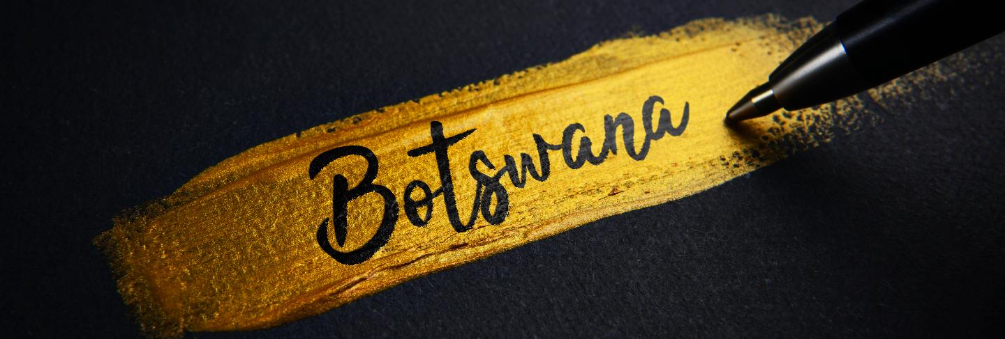 Botswana handwriting text on golden paint brush stroke