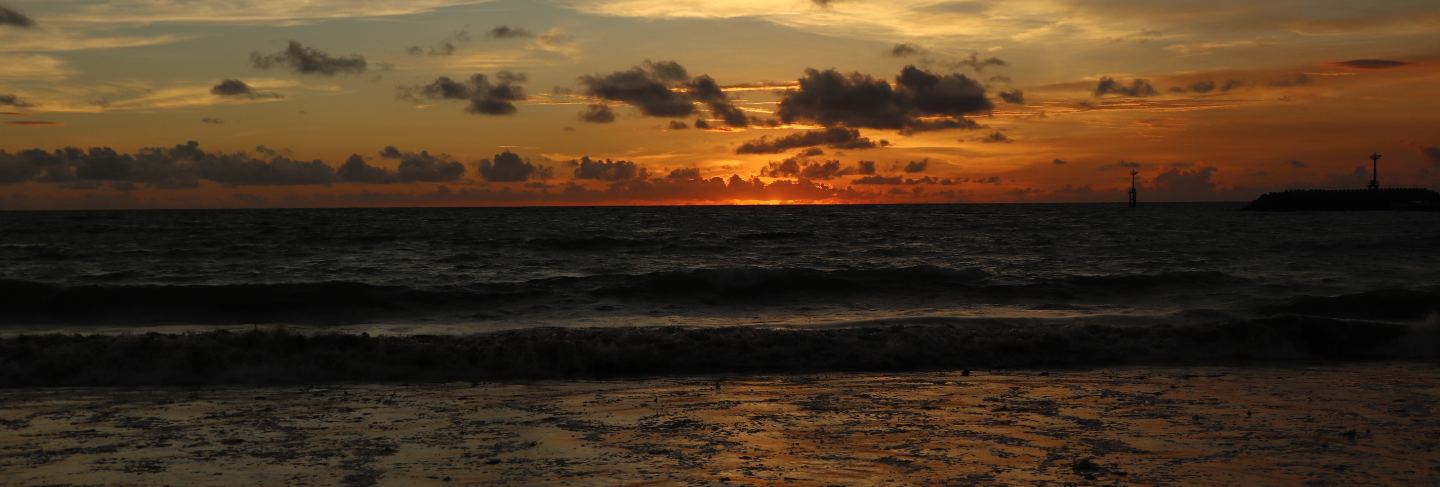 Beautiful scenery at the beach with sunset and clouds in bali, indonesia 
