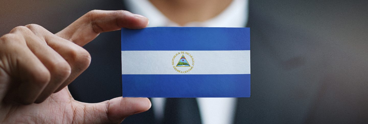 Businessman holding card nicaragua flag
