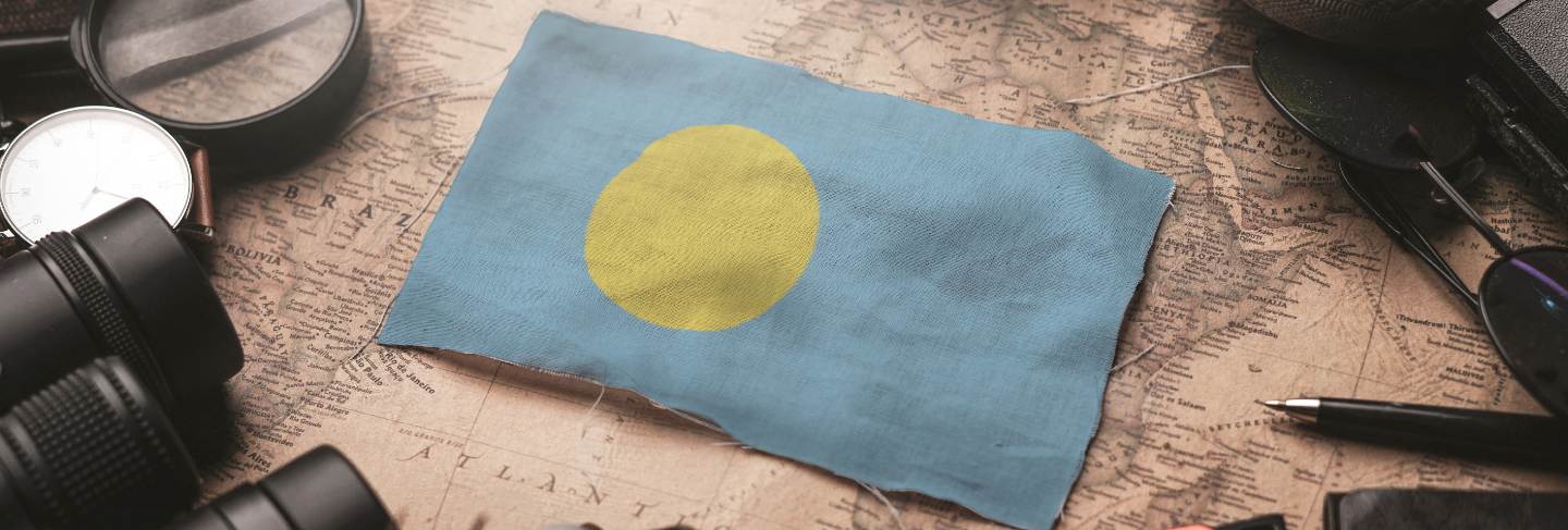 Palau flag between traveler's accessories on old vintage map. tourist destination concept