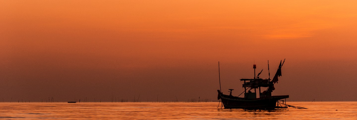 Silhouette of fishing boat with sunset in Trinidad And Tobago
