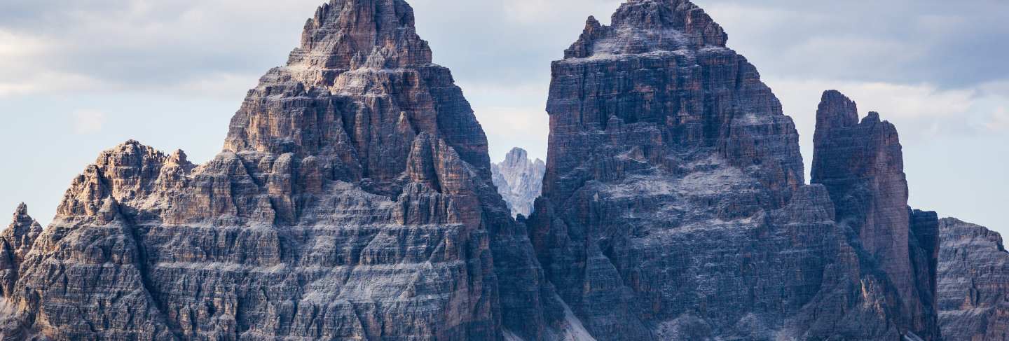 Beautiful shot of the tre cime di lavaredo mountains with a cloudy sky
