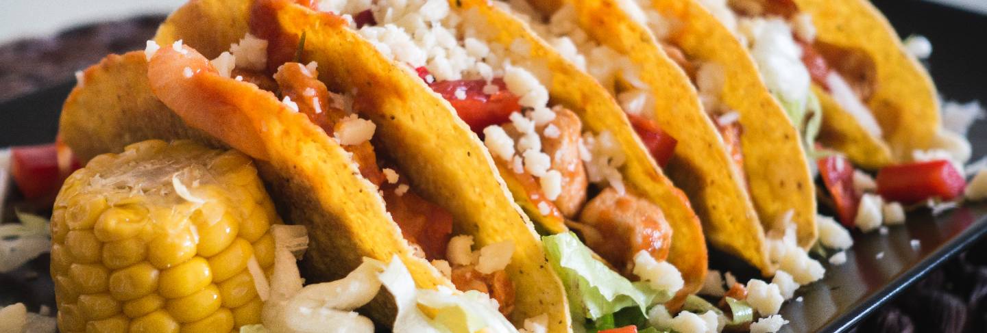 Homemade chicken tacos with corn and cheese
