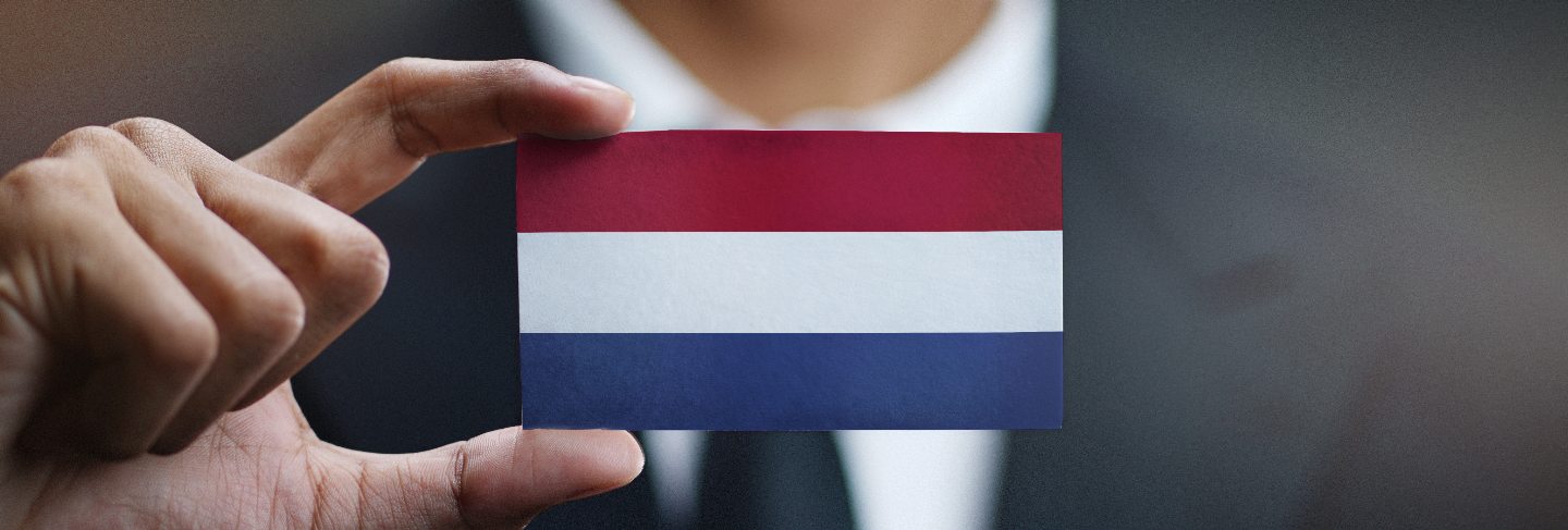 Businessman holding card of netherlands flag