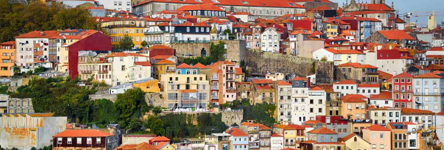 Porto, the ribeira district, portugal old town ribeira view with colorful houses, traditional facades, old multi-colored houses with red roof tiles
