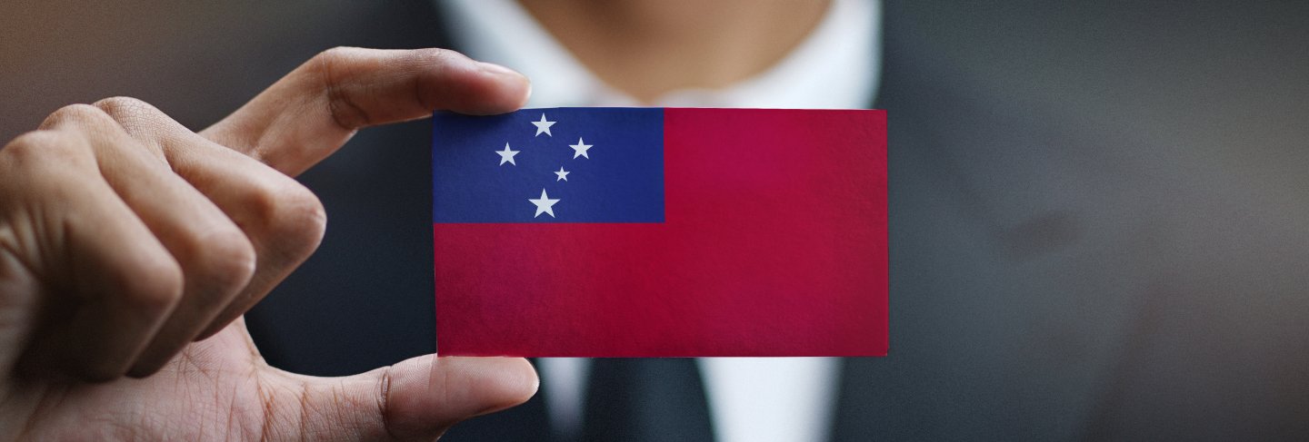  Businessman holding card of samoa flag
