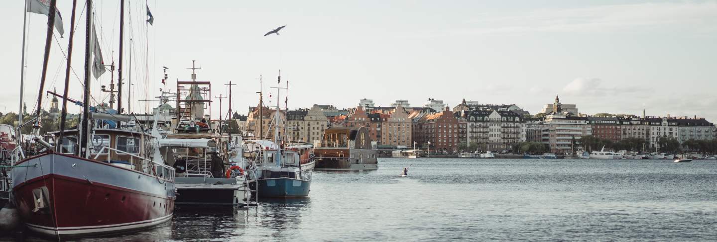 Sailing boats and yachts on the pier in stockholm front of the city center
