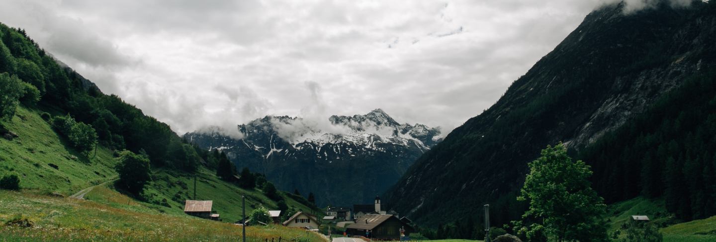 Road in Swiss Alps mountains in summer cloudy weather