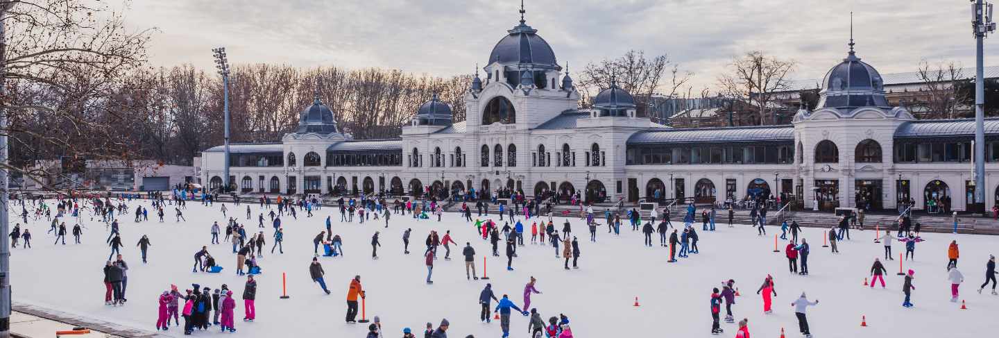 Many people spend their holidays skating in city park ice rink in budapest, hungary
