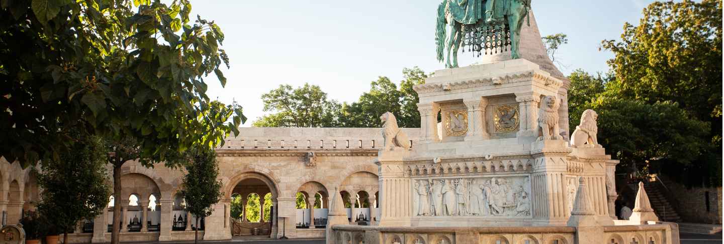 The famous fisherman's bastion at sunrise with statue of king stephen i and parliament of hungary
