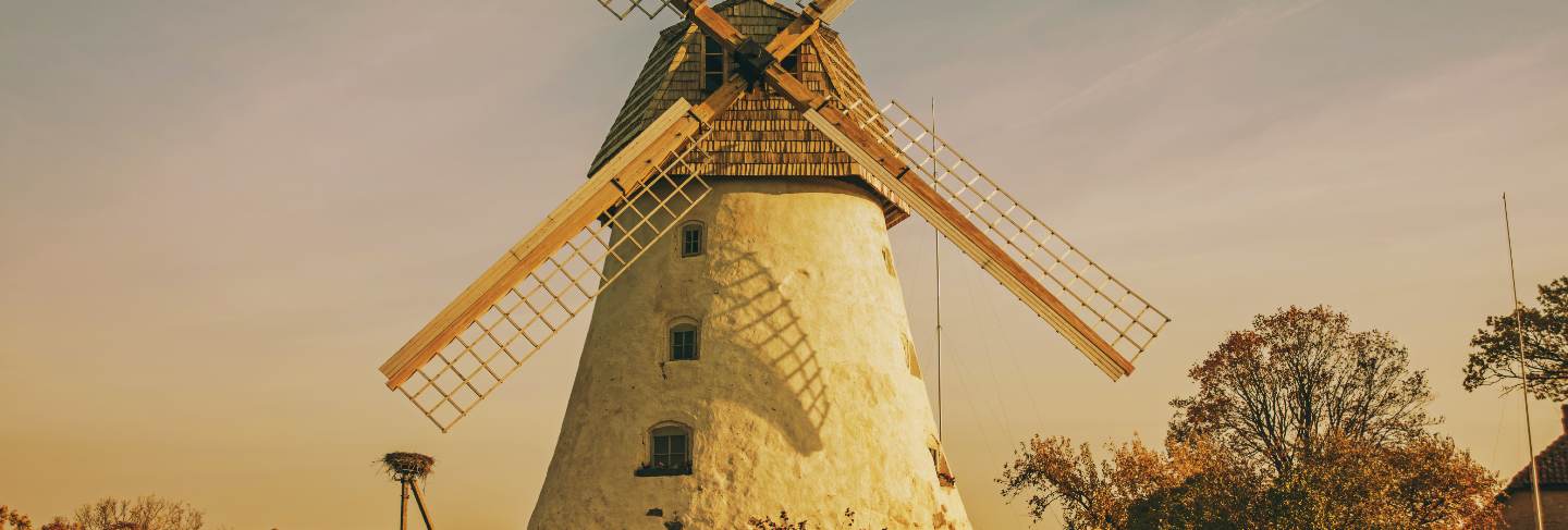 Restored old windmill on the mountainside. autumn sunny day.
