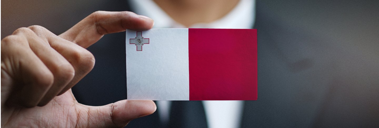 Businessman holding card of malta flag Premium Photo
