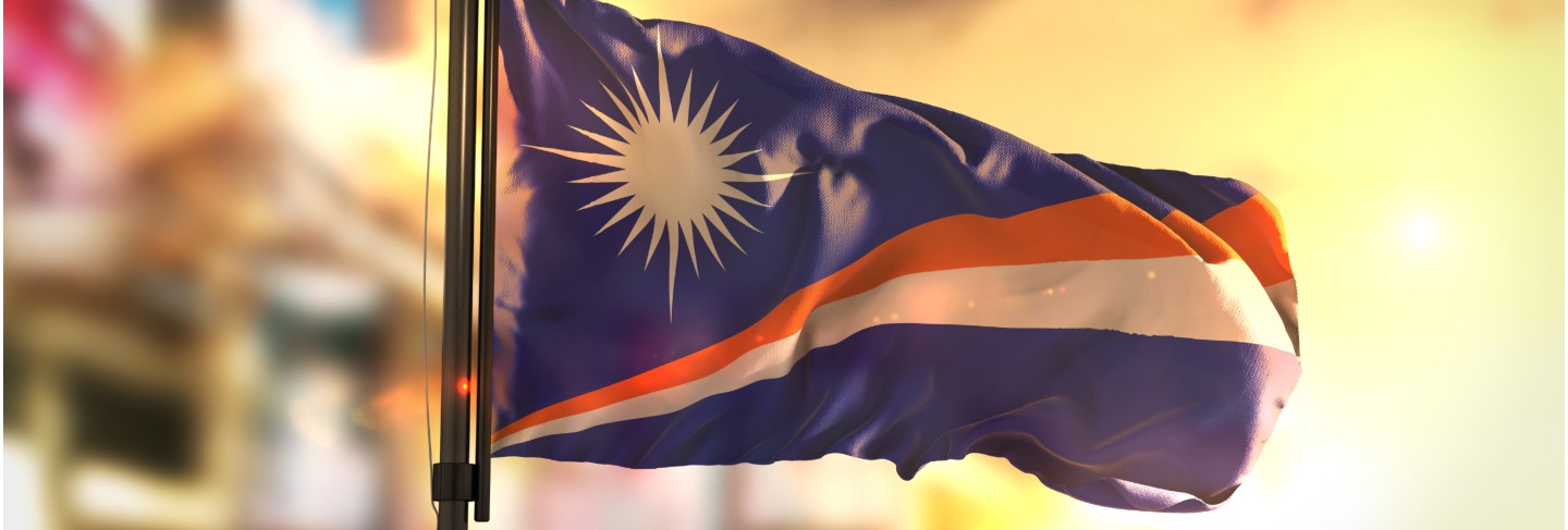 Marshall islands flag against city blurred background at sunrise backlight Premium Photo