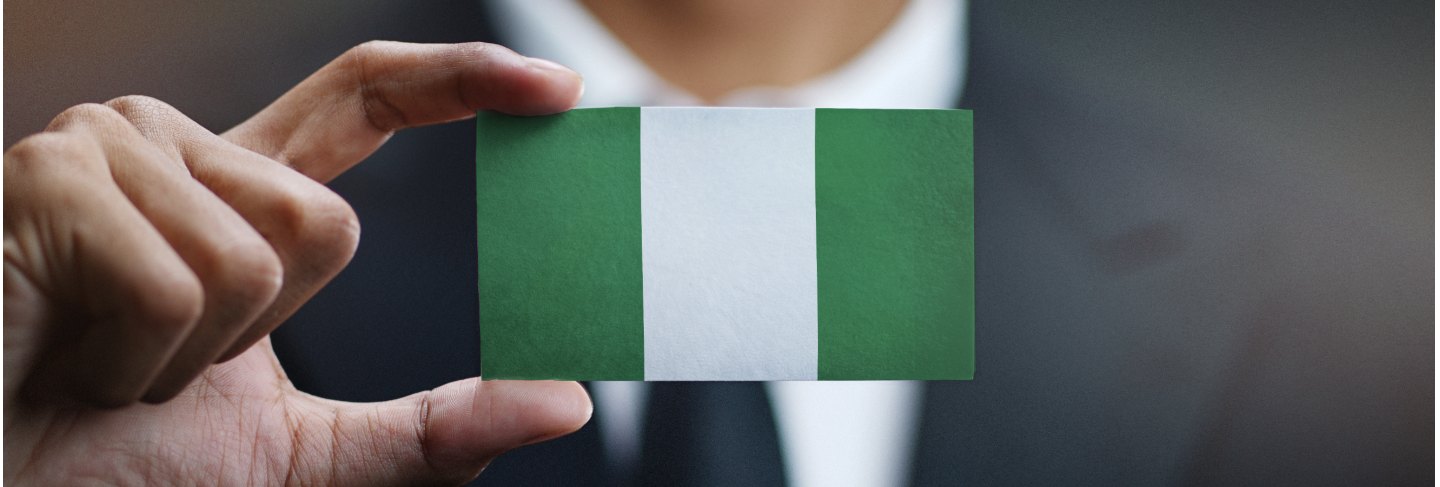 Businessman holding card nigeria flag
