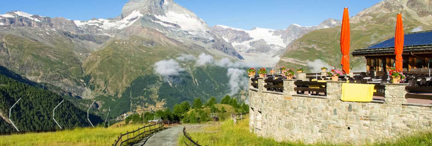 View of hiking trail in swiss alps, zermatt mountains area near Matterhorn peak in summer, Switzerland