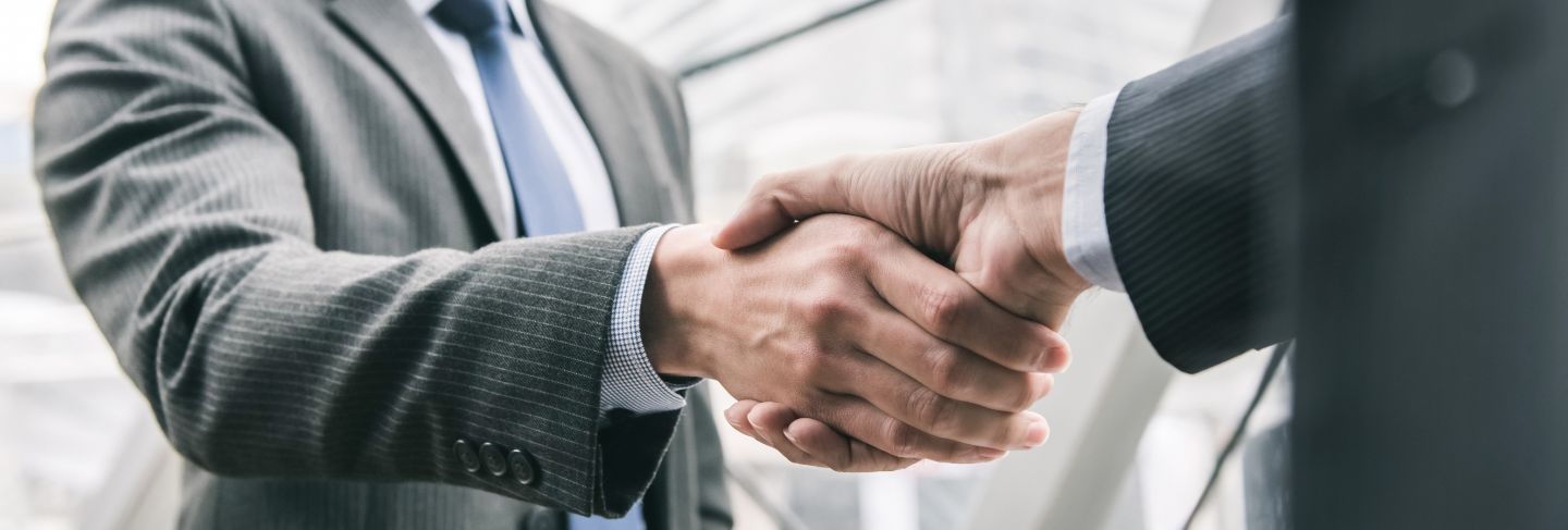 Businessman making handshake with partner

