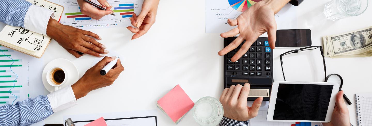 Close up detail of team working o new project in coworking space, writing ideas, looking through graphics on tablet and laptop. teamwork, business concept.
