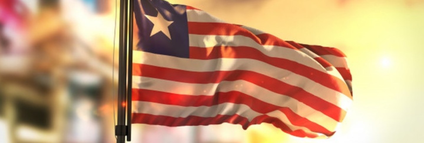 liberia-flag-against-city-blurred-background-sunrise-backlight_1379-1567
