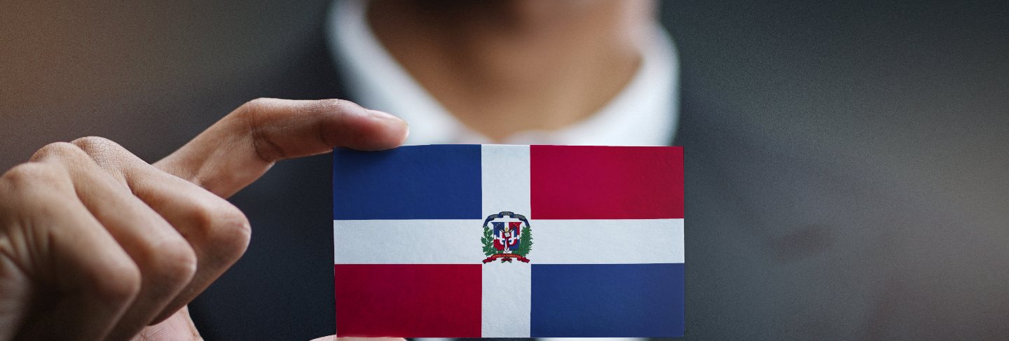 Businessman holding card of dominican republic flag
