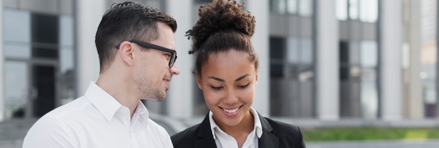 Business man showing ipad to woman
