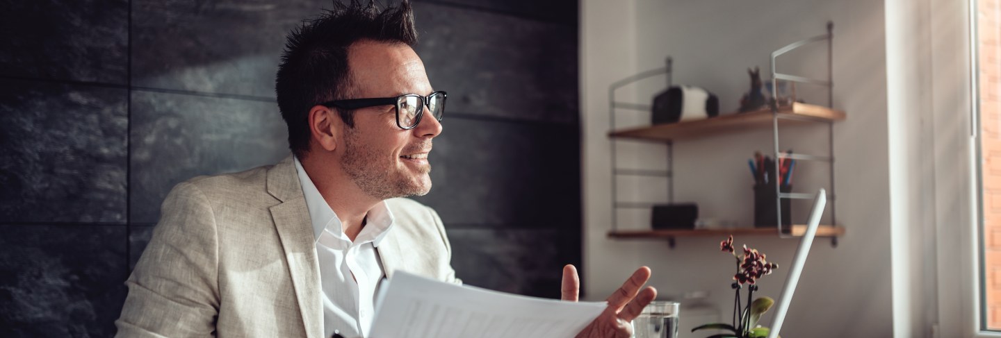 Businessman having online meeting in his office
