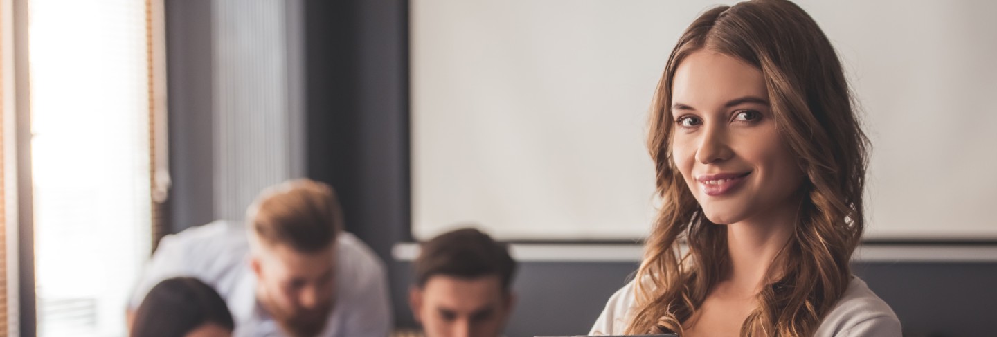 Beautiful young business lady is looking at camera
