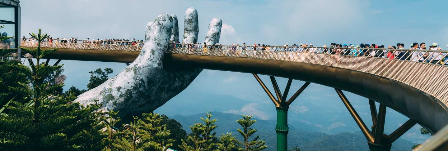 The golden bridge is lifted by two giant hands in the tourist resort on ba na hill in danang, vietnam. ba na hill mountain resort is a favorite destination for tourists of central vietnam
