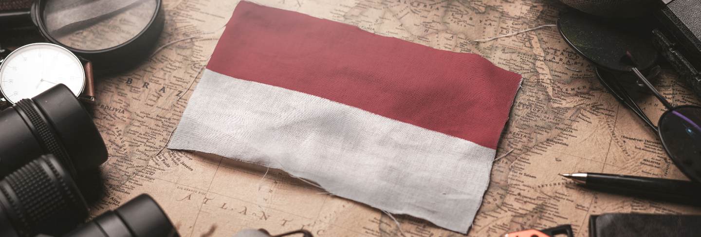 Indonesia flag between traveler's accessories on old vintage map. tourist destination concept

