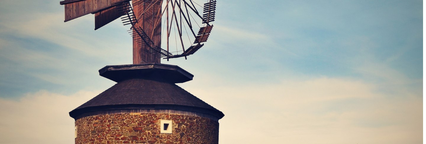 Beautiful old windmill at sunset with sky and clouds. ruprechtov - czech republic - europe.
