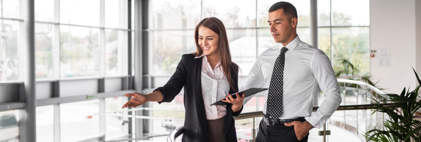 Man and woman walking together at dealership
