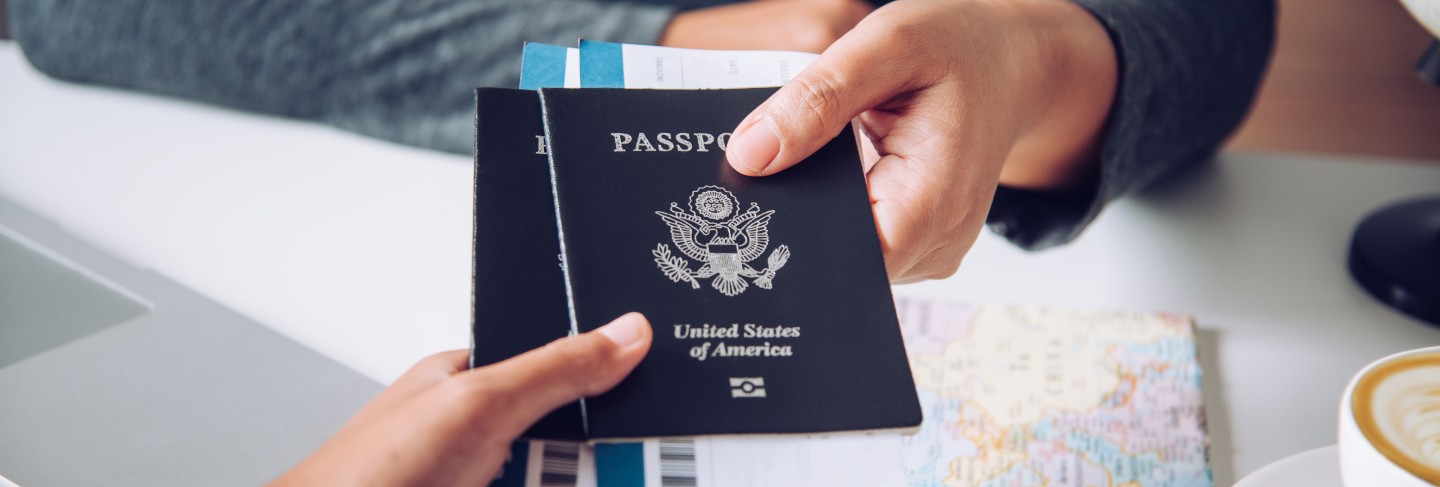 Hand for tourist holding passport to authorities
